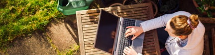 Woman working on laptop outside